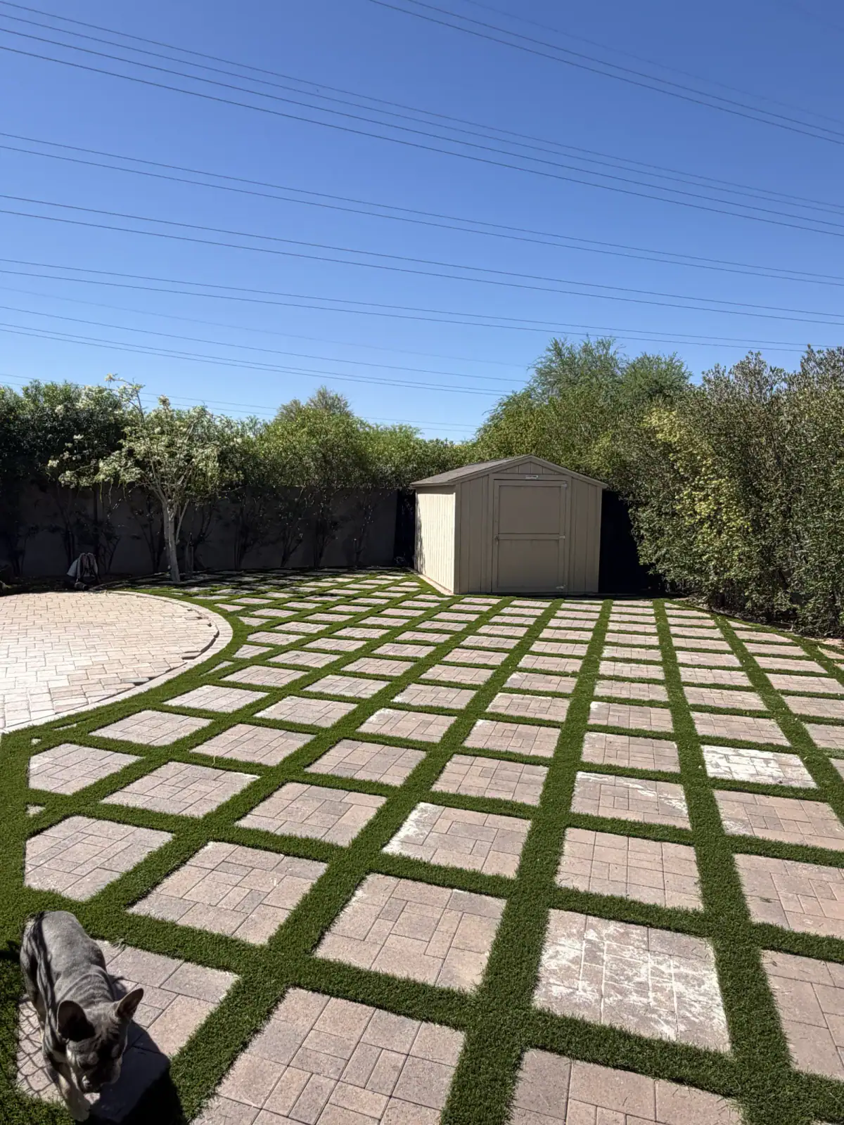 The finished paver and artificial turf yard
